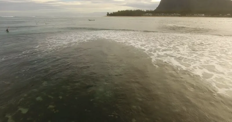 Whitewater spreading over the Le Morne reef, seen from a low-flying drone.