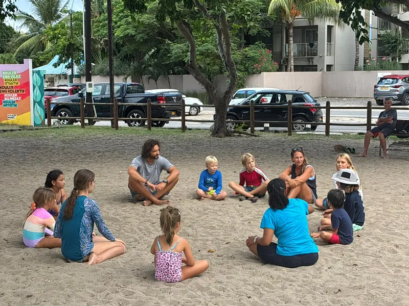 Warm-up circle on the sand under the big tree.
