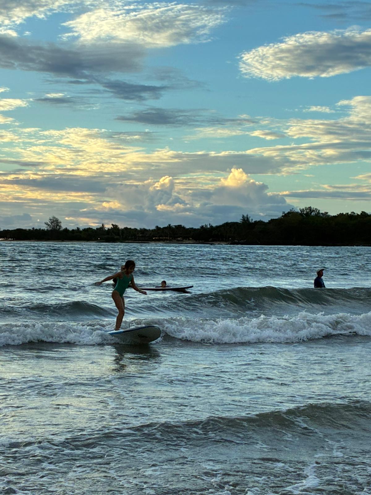 A young surfer riding a wave in Tamarin
